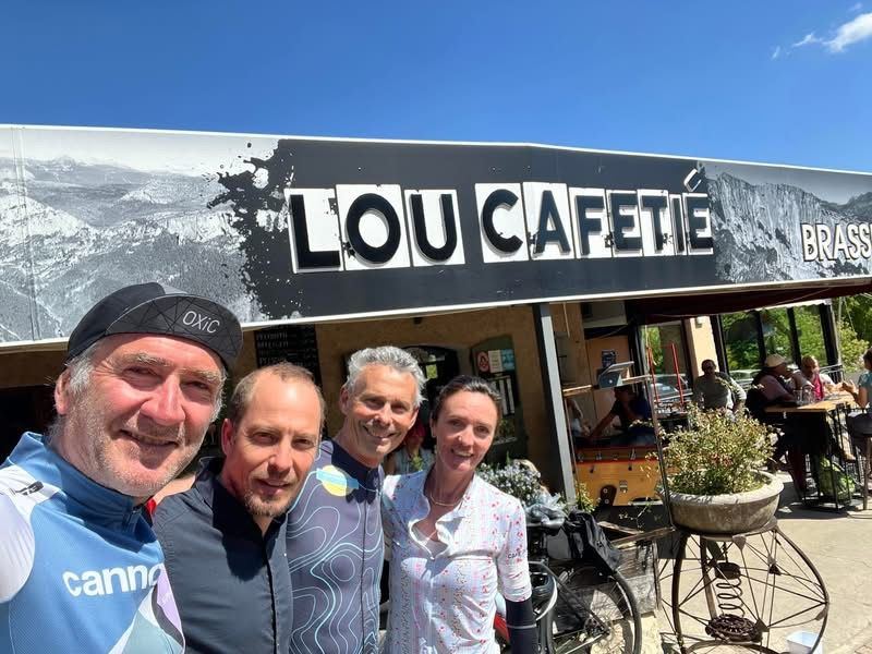 Des cyclistes devant l’enseigne du Lou Cafetié